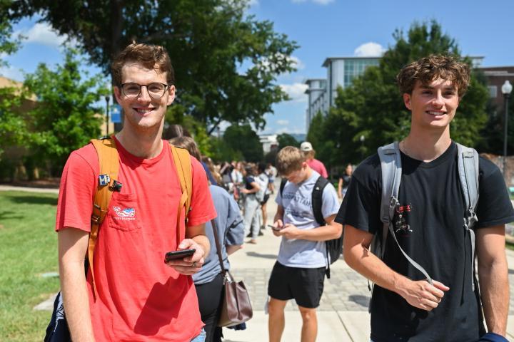 Male students standing in line at a campus event